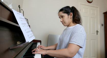 A young woman playing the piano