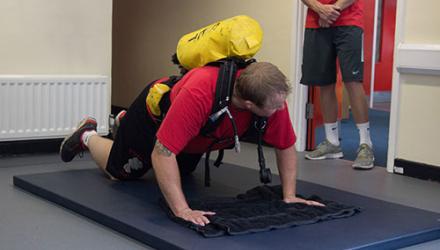 Firefighter doing a press up