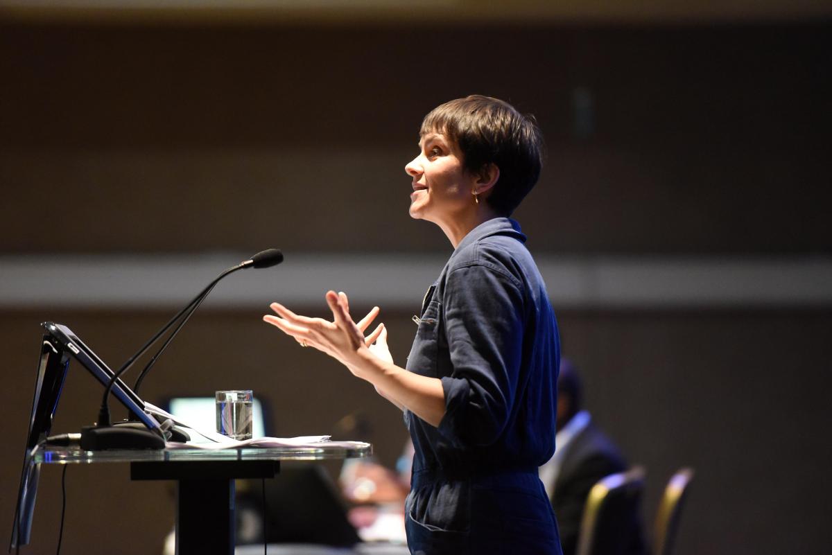 Side-on shot of someone at a lectern